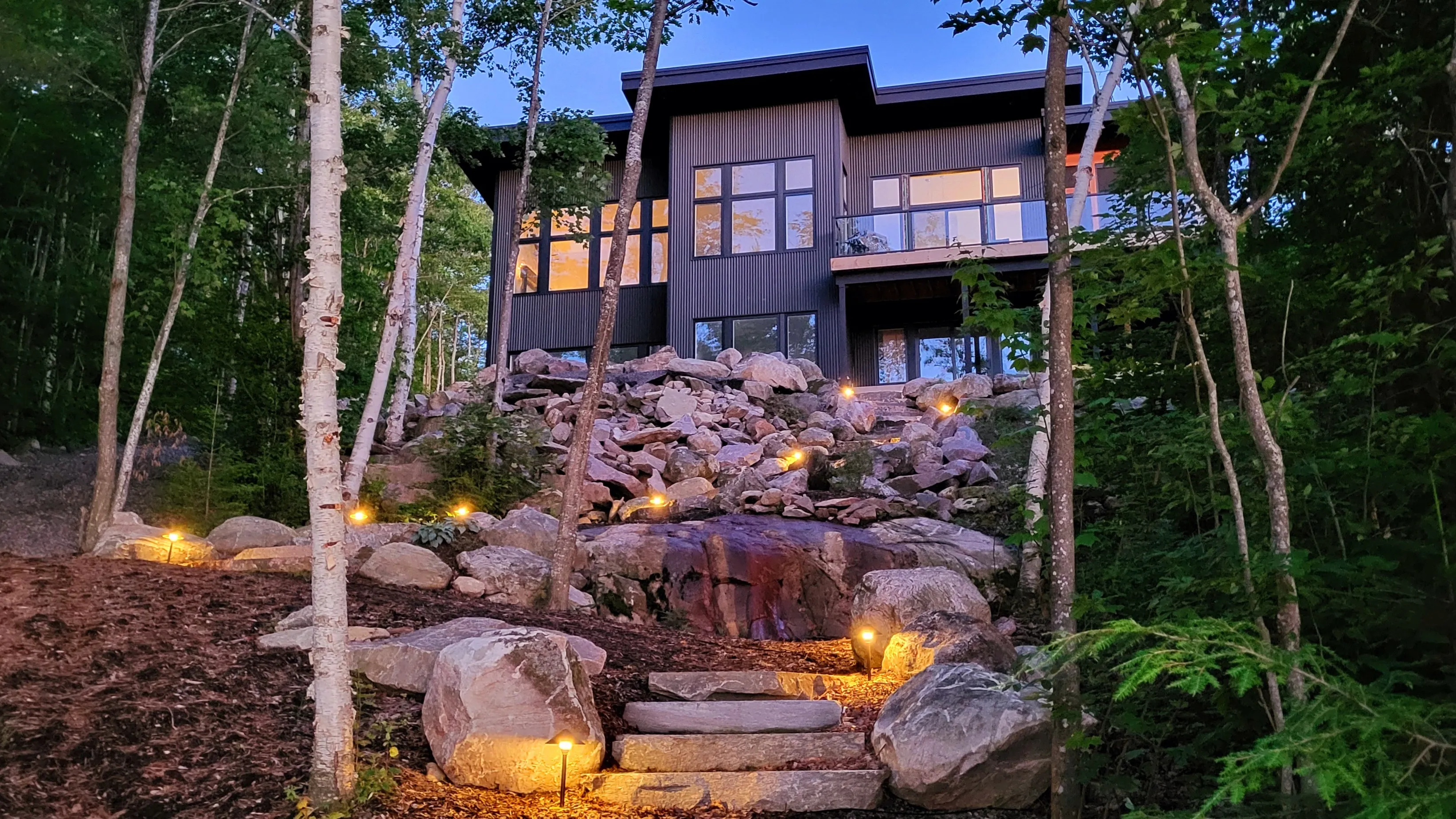 Completed lakeside cottage exterior at dusk